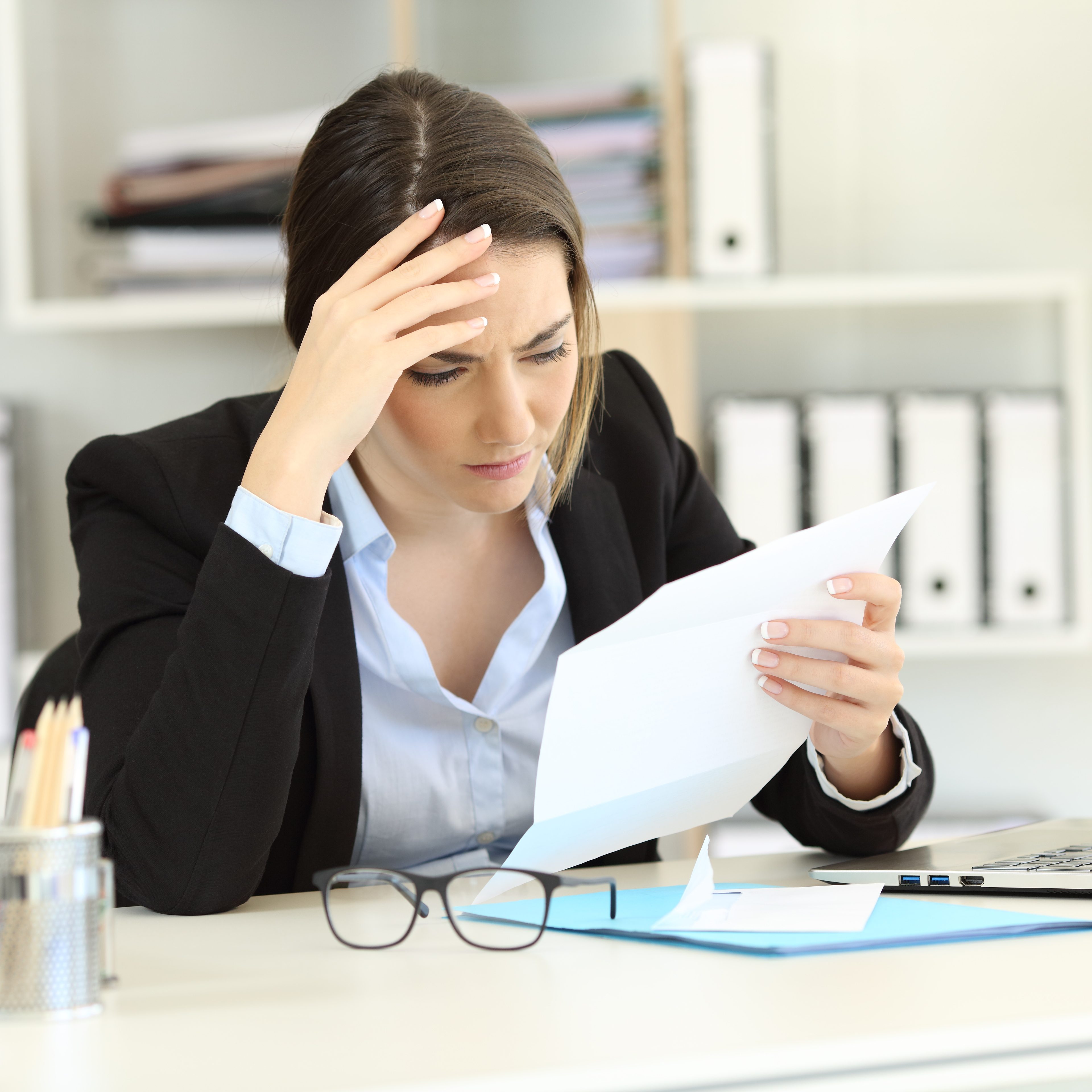 Worried,Executive,Reading,Bad,News,In,A,Letter,At,Office