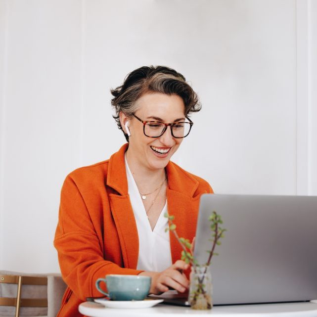 Mature,Businesswoman,Smiling,Cheerfully,During,A,Virtual,Meeting,With,A